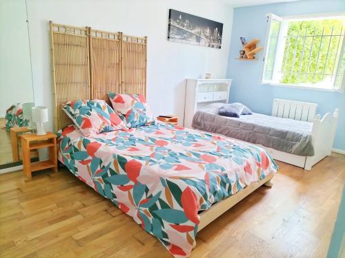 - une chambre avec un lit, un petit lit et une fenêtre dans l'établissement Rez de villa au calme proche de la plage, à Fréjus