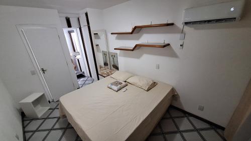 a small bedroom with a bed in a room at Casa 02 Quartos em frente às Praias mais belas de Salvador in Salvador