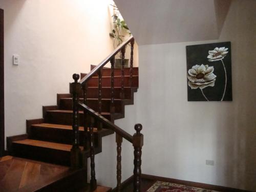 a staircase with a painting of flowers on the wall at Hostal Santa María Gracia in Quito
