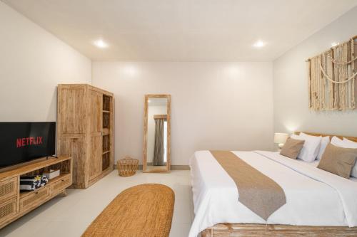 a bedroom with a bed and a flat screen tv at ☆ Villa Larissa ☆ Seminyak 2BR Pool Kuta Petitenget in Seminyak