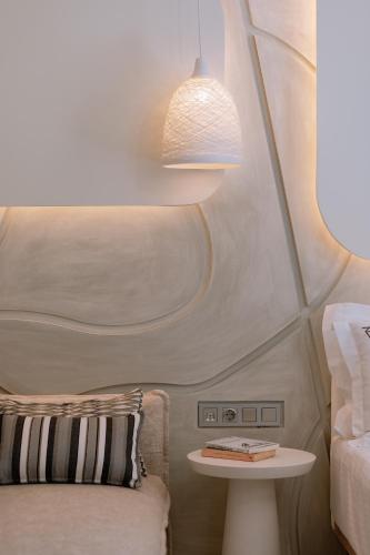 a room with a bed and a table with a lamp at ZEST THASSOS LUXURY RETREAT in Limenaria