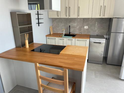 a kitchen with a wooden counter top and a refrigerator at S3 Apartment 1 in Margjonaj