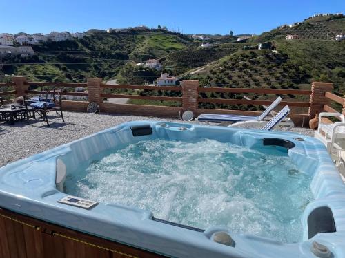 a jacuzzi tub on a patio with a view at Evans Realty BQ Casa Vallejo & Jacuzzi & BBQ & Vistas in Borge