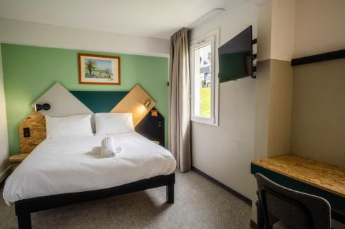 a bedroom with a white bed with a window at greet Hôtel Montbéliard in Montbéliard