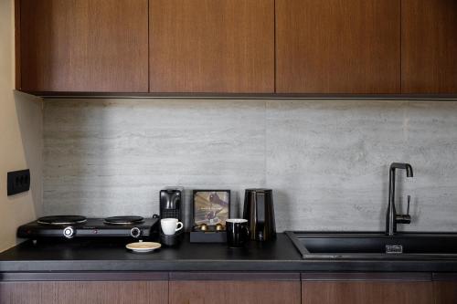 a kitchen counter top with a stove and a sink at Hidden Hills in Mesaria