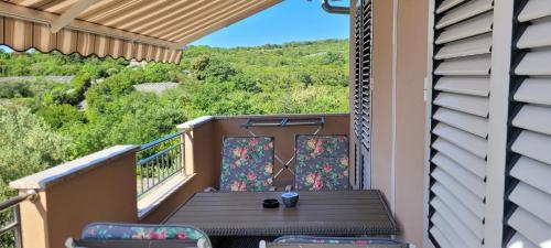 a balcony with a table and chairs on it at Apartments in Krk in Krk