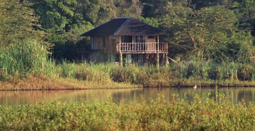 a house sitting on the side of a body of water at Mukima Manor in Nanyuki