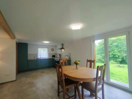 une cuisine et une salle à manger avec une table et des chaises dans l'établissement Achille, à Manspach