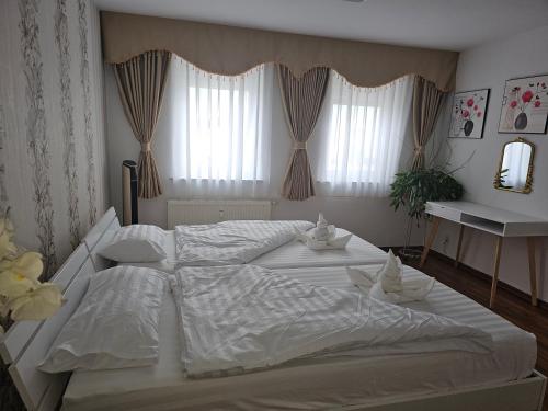 a large white bed in a bedroom with curtains at Käthe-Kollwitz - Straße 54, F3 in Altenburg