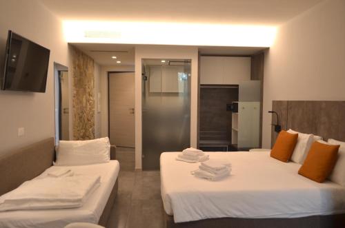 a hotel room with two beds with towels on them at La Cipressina B&B in Cavaion Veronese