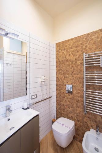 a bathroom with a toilet and a sink at Little Rock Guest House in Gaeta
