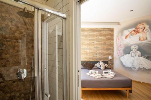 a bathroom with a bed and a shower at Little Rock Guest House in Gaeta