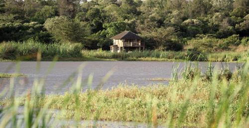 a small shack in the middle of a body of water at Mukima Manor in Nanyuki