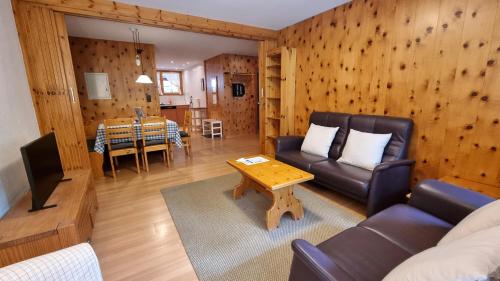 a living room with a couch and a table at Dent Blanche in Zermatt