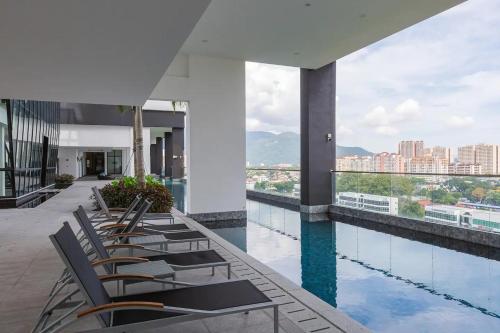 a row of chairs sitting on top of a building at Tatami with HomeCinema, 9pax, Urban Suites by PG Home in George Town