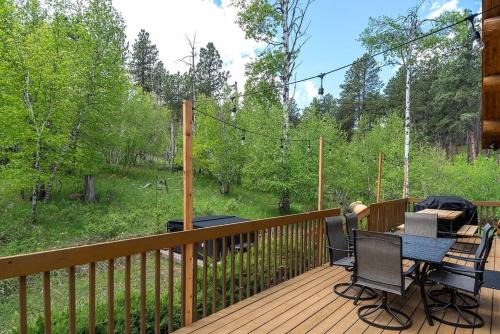 a patio with a table and chairs on a deck at Peaceful Valley Hideaway in Rapid City