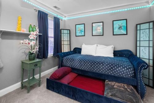 a bedroom with a blue bed with a red blanket at New Tropical Island Oasis in Baltimore