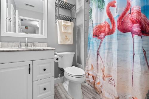 a bathroom with a pink flamingos shower curtain at New Tropical Island Oasis in Baltimore