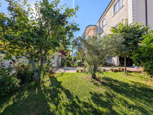 a yard with two trees and a building at Villa with Garden & Balcony in Berat