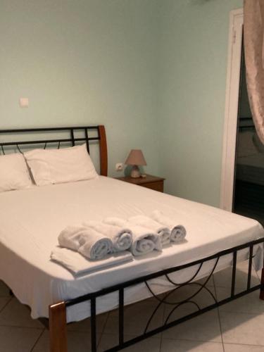 a bedroom with a bed with towels on it at Ammodares in Lixouri
