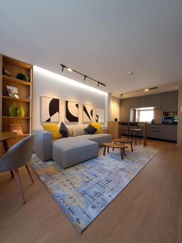 a living room with a couch and a table at Casa das Flores in Bragança
