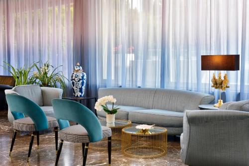 a living room with a couch and chairs and a table at Hotel Continental Wellness & Spa in Sirmione