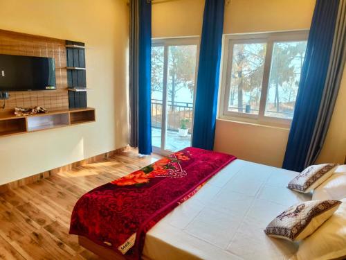 a bedroom with a bed with a red blanket on it at Monarch Hills in Lansdowne