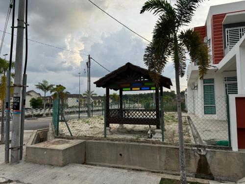 a bus stop on the side of a street at Acik Homestay in Pokok Sena