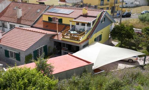 an overhead view of a house with a large white roof at Sun house - Near Sintra - Kitchen - Pool in Sintra
