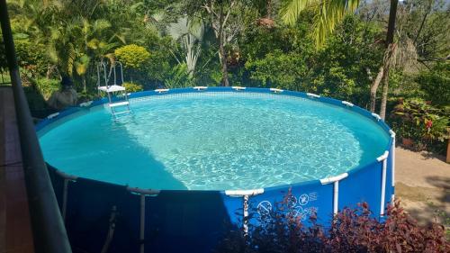 a large pool of water with a chair in it at Finca San Jerónimo in Arbeláez