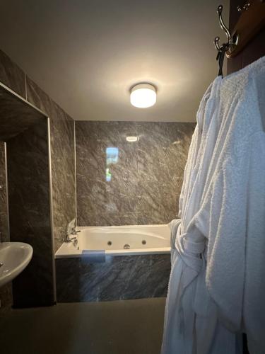 a bathroom with a bath tub and a sink at The Old Vicarage in Ambleside