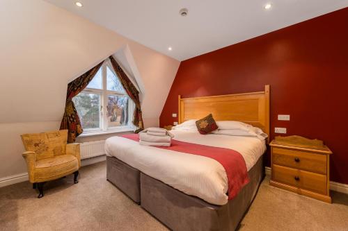 a bedroom with a large bed and a window at The Old Vicarage in Ambleside
