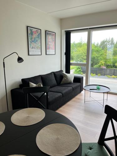 a living room with a couch and a table at Casa House of bricks 3 - LEGO HOUSE 300 meters - Town center 200 meters in Billund