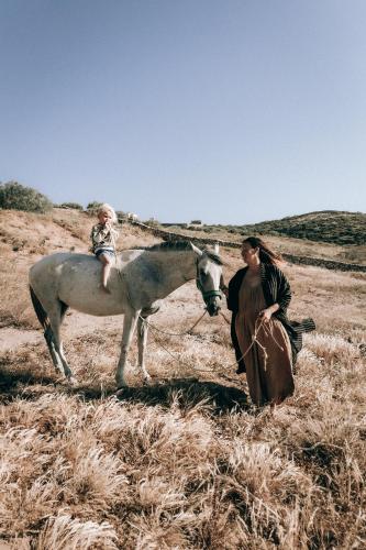 a woman riding a horse next to a man and a girl at ALNA mogador in Akermoud