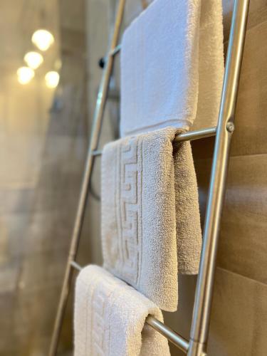a bunch of towels hanging on a towel rack at Ank's Apartment in Ocna-Mureşului