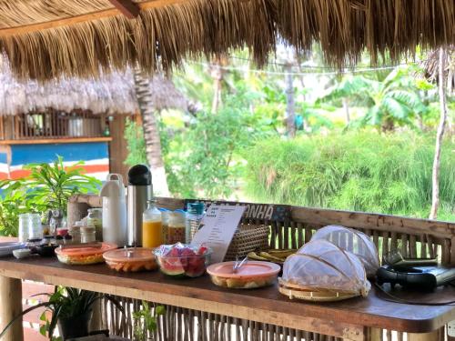 a wooden table with food on top of it at Pousada Maré Cheia in Itarema