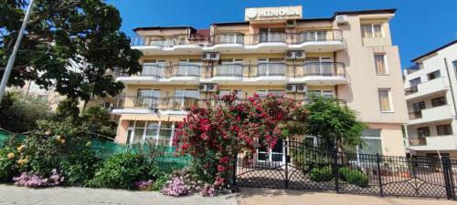 a building with flowers in front of it at Family Hotel Mimosa in Tsarevo