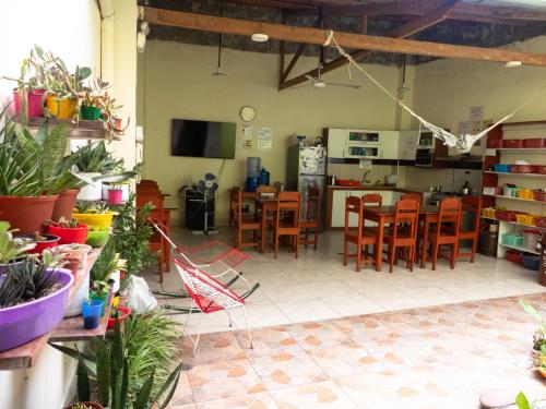 a kitchen and dining room with a table and chairs at Moicca Youth Hostel in Iquitos