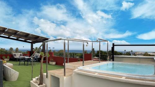 a swimming pool on the roof of a house at Atrium Hotel in Bolnuevo
