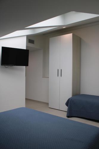 a bedroom with a bed and a flat screen tv at Dimora Saracena in Termoli