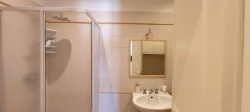 a bathroom with a shower and a sink and a mirror at Villa Libertà in Siracusa