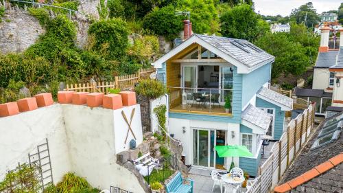 an aerial view of a blue house at The Boathouse - Panoramic Sea View Retreat, near Town, Marina & Beach, with Parking in Torquay