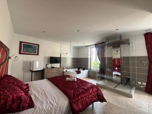 a bedroom with a large bed with a glass wall at La Suite Love de l Écu in Villeneuve-sur-Yonne