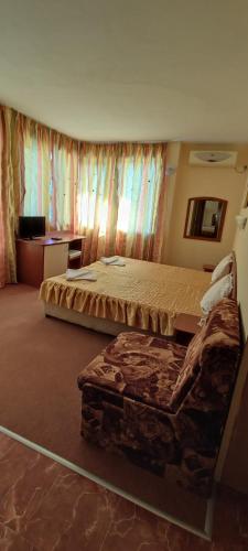 a hotel room with two beds and a couch at Family Hotel Mimosa in Tsarevo