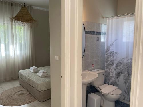 a bathroom with a toilet and a sink at Stefanos Home in Katelios