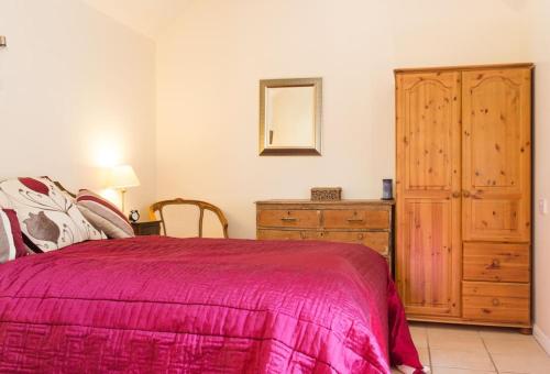 a bedroom with a bed and a dresser and a mirror at The Doghouse near Silverstone in Buckingham