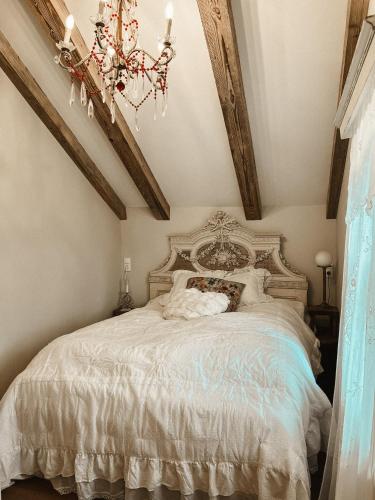 a bedroom with a large bed with a chandelier at Evas Boutique Alm in Kloster
