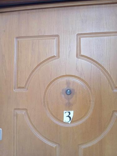 a wooden door with a number on it at Chrisa apartament in Metogjashta