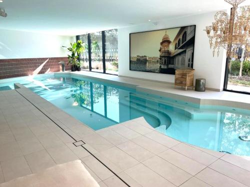 a large swimming pool in a house with a tv at RESIDENCE SERVICES MONTANA Paris Clichy in Clichy