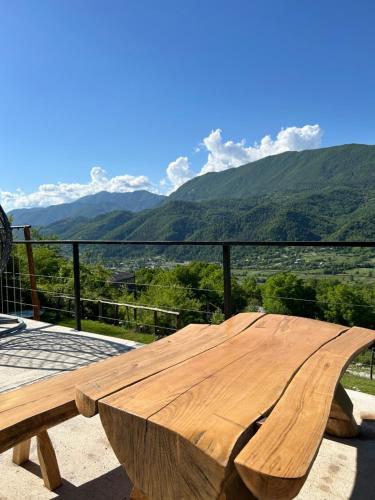 a wooden table with a view of mountains at Ramona in Ambrolauri